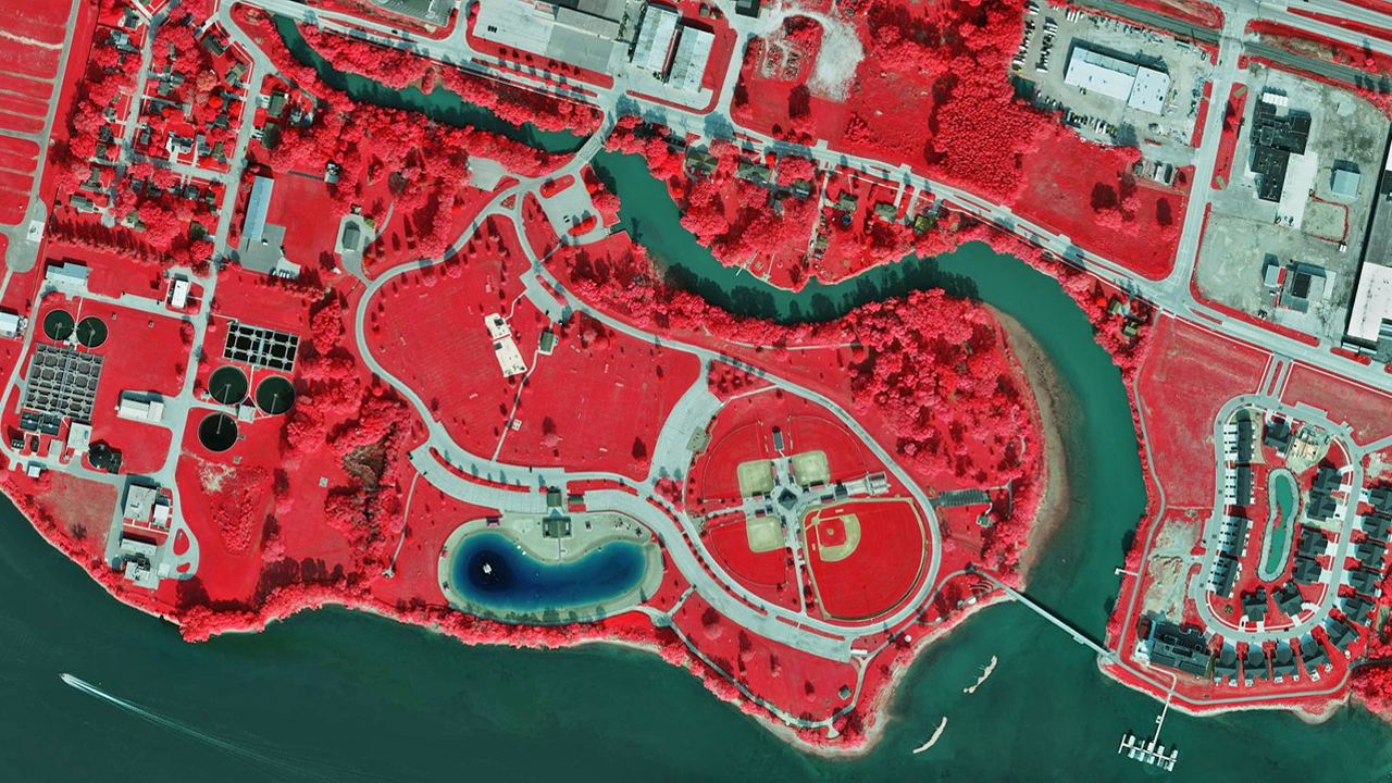 Multispectral aerial image of a park next to water in Green Bay, WI, published by Vexcel.
