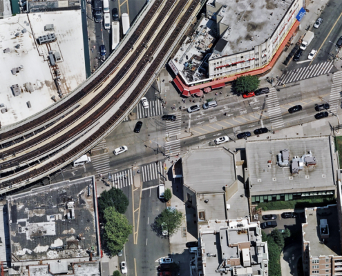Oblique aerial image of an urban intersection and railway line in Brooklyn, NY, published by Vexcel.